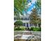 Charming townhome featuring a blue front door with a wreath, flanked by lush greenery and trees at 541 Campus St, Celebration, FL 34747