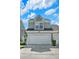 Two-story townhome with a two-car garage, presenting a clean facade and neatly maintained landscaping at 541 Campus St, Celebration, FL 34747