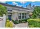 Beautifully landscaped townhouse exterior with a welcoming blue front door and well-maintained greenery at 541 Campus St, Celebration, FL 34747