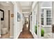 Bright hallway with hardwood floors leading to rooms and exterior door at 541 Campus St, Celebration, FL 34747
