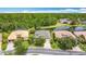 Overhead view of homes and landscaping with a lake in the background on a sunny day at 567 Villa Park Rd, Kissimmee, FL 34759