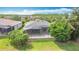 A charming home boasts a large, screened-in patio and lush tropical landscaping in a desirable community at 567 Villa Park Rd, Kissimmee, FL 34759