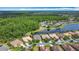 High angle of real estate in a green area alongside a lake in a residential neighborhood at 567 Villa Park Rd, Kissimmee, FL 34759
