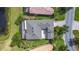 Aerial view of home with a screened in lanai, lake view, and meticulous landscaping at 567 Villa Park Rd, Kissimmee, FL 34759