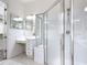 The bathroom boasts a sleek glass shower and a vanity area with ample lighting at 567 Villa Park Rd, Kissimmee, FL 34759