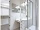 Well-lit bathroom with a spacious shower, makeup vanity and closet access at 567 Villa Park Rd, Kissimmee, FL 34759