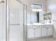 This bathroom features a double vanity and a walk-in shower at 567 Villa Park Rd, Kissimmee, FL 34759