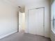 Bedroom featuring carpeted floors, a closet, and a window, offering a comfortable living space at 567 Villa Park Rd, Kissimmee, FL 34759