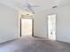 Spacious bedroom with neutral carpet and views to the hallway and bathroom at 567 Villa Park Rd, Kissimmee, FL 34759