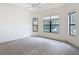 This airy bedroom is bright with natural light and features plush carpet and a ceiling fan at 567 Villa Park Rd, Kissimmee, FL 34759