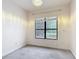 Cozy bedroom featuring carpeted floors and a window with a peaceful view of the outdoors at 567 Villa Park Rd, Kissimmee, FL 34759