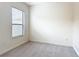 Bedroom with plush carpeting and a window offering natural light at 567 Villa Park Rd, Kissimmee, FL 34759
