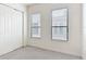 Bright bedroom with carpet, a closet, and windows providing natural light at 567 Villa Park Rd, Kissimmee, FL 34759