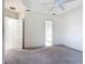 An airy bedroom with neutral carpet leads to a bathroom with a glass shower at 567 Villa Park Rd, Kissimmee, FL 34759