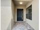 The entryway of the home features a dark front door, overhead light, and a large window at 567 Villa Park Rd, Kissimmee, FL 34759