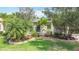 Well-manicured front yard with lush landscaping, verdant lawn, and attractive brick accents at 567 Villa Park Rd, Kissimmee, FL 34759