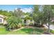 Lush landscaping and mature trees frame this home, enhancing its curb appeal and natural beauty at 567 Villa Park Rd, Kissimmee, FL 34759