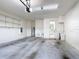 Spacious garage with epoxy floor, water heater, and interior access to the home at 567 Villa Park Rd, Kissimmee, FL 34759