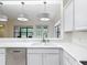 Bright kitchen area showcasing white counters and cabinets, stainless appliances, sink, and open floorplan at 567 Villa Park Rd, Kissimmee, FL 34759