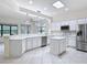 Open kitchen featuring white cabinets, stainless steel appliances, a peninsula, and an island at 567 Villa Park Rd, Kissimmee, FL 34759