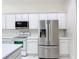 Kitchen area showcasing stainless appliances and white cabinets at 567 Villa Park Rd, Kissimmee, FL 34759