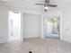 Bright, open living space with doorways leading to other rooms, featuring tile floors and modern lighting at 567 Villa Park Rd, Kissimmee, FL 34759