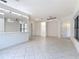 Spacious open-concept living area with tile floors and bright lighting from several ceiling fans at 567 Villa Park Rd, Kissimmee, FL 34759