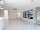 Bright, unstaged living room with white walls, tile flooring, and a view to the outside patio at 567 Villa Park Rd, Kissimmee, FL 34759