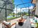 Enjoy a luxurious outdoor living space with screened patio overlooking the serene lake view at 567 Villa Park Rd, Kissimmee, FL 34759