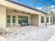 Screened in patio with brick floor, three ceiling fans, and outdoor seating at 567 Villa Park Rd, Kissimmee, FL 34759