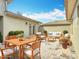An exterior patio area is shown with upscale outdoor seating and stone paver flooring at 567 Villa Park Rd, Kissimmee, FL 34759