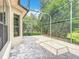 A screened-in patio area provides ample space for outdoor seating and overlooks lush greenery at 567 Villa Park Rd, Kissimmee, FL 34759