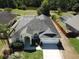 Aerial view of a home showcasing a large pool, backyard, and manicured lawn at 624 Montana Ave, Davenport, FL 33897