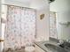 Bathroom featuring neutral tiles, a patterned shower curtain, and a large vanity at 624 Montana Ave, Davenport, FL 33897