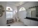 A unique bathroom featuring tile flooring, stained glass windows, white fixtures, and seahorse-themed decor at 624 Montana Ave, Davenport, FL 33897