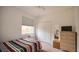 Cozy bedroom with a neutral carpet, large window and a comfortable bed at 624 Montana Ave, Davenport, FL 33897