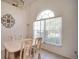 Elegant dining room with arched window, chandelier, and seating for four for comfortable Gathering meals at 624 Montana Ave, Davenport, FL 33897