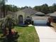 Charming single-story home featuring a well-kept lawn, mature trees, and a two-car garage at 624 Montana Ave, Davenport, FL 33897