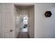 A hallway featuring a carpet floor, white walls, and a decorative seahorse wall hanging at 624 Montana Ave, Davenport, FL 33897