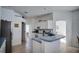 Open-concept kitchen featuring white cabinetry, blue countertops, and seamless flow to adjacent living spaces at 624 Montana Ave, Davenport, FL 33897