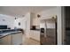 Kitchen featuring stainless steel refrigerator, white cabinetry, and functional layout at 624 Montana Ave, Davenport, FL 33897