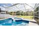 Lovely in-ground pool and hot tub featuring a screen enclosure at 624 Montana Ave, Davenport, FL 33897