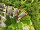 Aerial view of the home's landscaped yard with a seating area, complemented by mature trees offering privacy at 6886 Sundrop St, Harmony, FL 34773