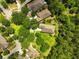 Aerial view highlighting the home's position on a well-manicured lot, surrounded by lush trees and mature landscaping at 6886 Sundrop St, Harmony, FL 34773