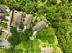 Aerial view of the home's landscaped yard with a seating area, complemented by mature trees offering privacy at 6886 Sundrop St, Harmony, FL 34773