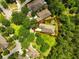 Aerial view highlighting the home's position on a well-manicured lot, surrounded by lush trees and mature landscaping at 6886 Sundrop St, Harmony, FL 34773