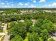 Overhead view of a home nestled amongst mature trees and landscaping within a leafy residential neighborhood at 6886 Sundrop St, Harmony, FL 34773