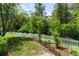 Beautiful backyard featuring lush landscaping and white picket fence at 6886 Sundrop St, Harmony, FL 34773