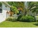 This backyard is surrounded by a beautiful tropical landscape and white picket fence at 6886 Sundrop St, Harmony, FL 34773