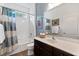 Well-lit bathroom with a shower-tub combo and a modern vanity at 6886 Sundrop St, Harmony, FL 34773